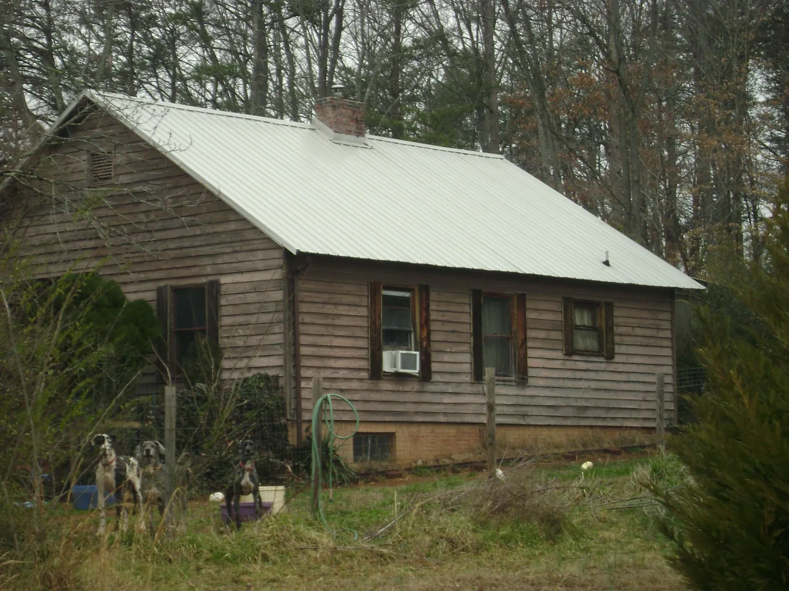 White metal roof on an old wood sided farmhouse, from a Metal Roof Installation job in Edgewood